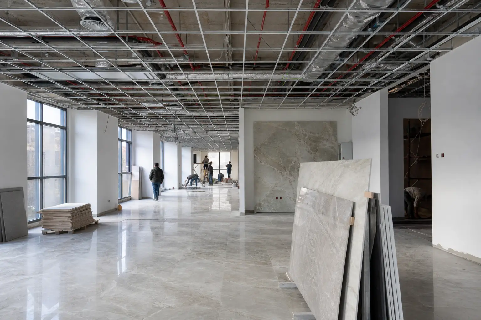 Commercial office fit-out in Damascus showing ceiling grid MEP coordination during construction